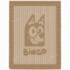 Beige knit and purl blanket with a textured Bingo character motif and “bingo” lettering, framed by a garter stitch border on a light background