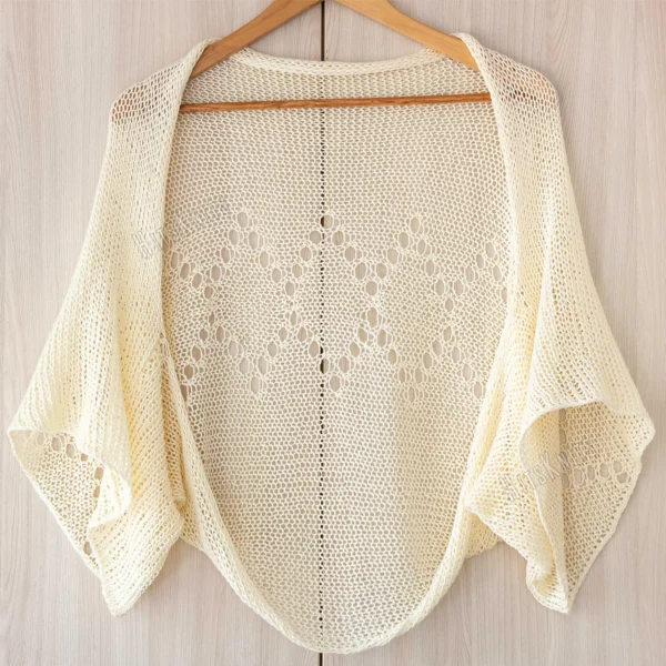 Ivory lace diamond shrug knitting pattern, lightweight summer cotton bolero, womens dress cover up, open knit crop cardigan, airy texture, elbow length sleeves, hanger view