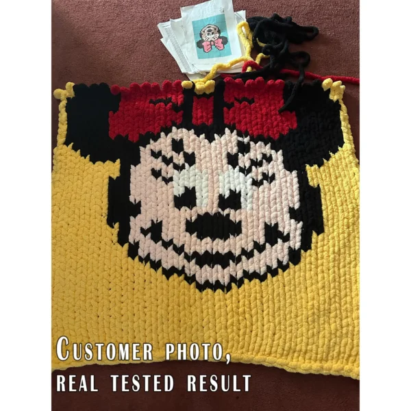 Minnie Mouse face knitting chart blanket in mint green background with pink bow, chunky yarn, pixel-style design, cozy handmade baby blanket
