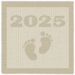 Minimalist knitted baby blanket with “2025” and baby feet motif in textured garter stitch on a smooth stockinette background, finished with a wide garter stitch border. Neutral cream newborn blanket design for stroller, nursery, baby shower gift, or pregnancy announcement photo prop.