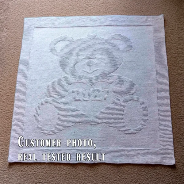 Sweet Teddy Bear 2027 Baby Blanket Knitting Pattern featuring a textured teddy bear holding a heart with “2027” inside. Knit using only knit and purl stitches, this beginner-friendly blanket creates a beautiful raised effect with garter stitch and stockinette contrast. Perfect as a newborn keepsake, crib blanket, stroller blanket, nursery décor piece, or baby shower gift.