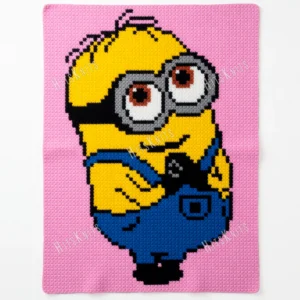 Minion Dave full-body C2C crochet blanket in baby pink background, yellow character with silver goggles and blue overalls, pixel-style design, cute handmade baby blanket