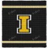 Iowa Hawkeyes varsity style chunky knit blanket featuring a bold yellow letter I outlined in white on a black background with sporty stripe accents, handmade with plush jumbo chenille yarn in a cozy finger knitting graphghan design.