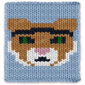 Kentucky Wildcat chunky knit blanket pattern featuring a close-up portrait of a wildcat mascot face with camel fur, dark eyes with green pupils, pink nose and white muzzle markings, set against a sky blue background, knitted in jumbo yarn using finger knitting colorwork technique.