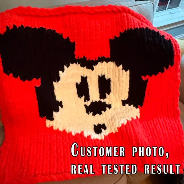 Mickey Mouse chunky knit blanket with classic black ears and white face on a bright red background, made in a pixel-style colorwork design using chunky chenille yarn. Cozy handmade blanket inspired by vintage cartoon characters and retro animation décor, suitable for nurseries, kids’ rooms, playrooms, and Disney-inspired interiors.