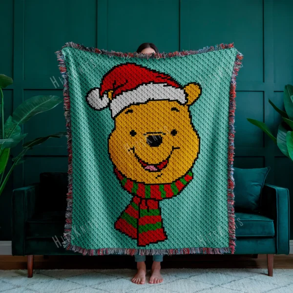 Christmas Winnie the Pooh C2C crochet blanket pattern featuring Pooh Bear in a Santa hat and striped scarf on a mint green background, handmade pixel graphghan blanket design.