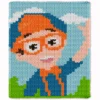 Pixel-style chunky knit blanket inspired by Blippi, featuring a cheerful character with bright orange glasses, orange hat, blue outfit, and smiling expression on a sky-blue background with white clouds and green grass.