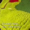 Golf-themed chunky knit blanket pattern featuring a green putting course with a red golf flag, golf hole, and white golf ball. The design is worked in chunky chenille-style stitches with bold shades of green, creating a soft and cozy sporty blanket perfect for golf lovers, boys’ rooms, game rooms, man caves, and handmade gifts.