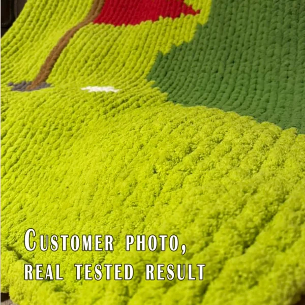 Golf-themed chunky knit blanket pattern featuring a green putting course with a red golf flag, golf hole, and white golf ball. The design is worked in chunky chenille-style stitches with bold shades of green, creating a soft and cozy sporty blanket perfect for golf lovers, boys’ rooms, game rooms, man caves, and handmade gifts.