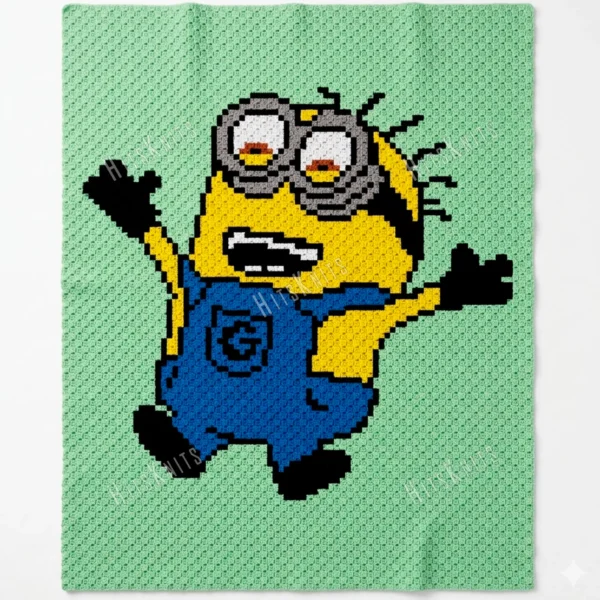 A playful corner-to-corner crochet blanket featuring a cheerful Minion character with raised arms, dressed in bright blue overalls with black gloves and shoes. The design is worked on a soft mint green background, making the bold yellow, blue, black, white, and gray details stand out beautifully.