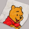 Pixel-style Winnie the Pooh C2C crochet blanket in soft plush yarn, featuring Pooh Bear wearing a red shirt on a light gray background. Handmade graphghan blanket with cartoon-inspired design and cozy textured stitches.