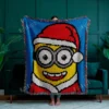 Christmas Minion C2C crochet blanket pattern featuring a Minion in a Santa hat and winter outfit on a bright blue background, handmade pixel graphghan blanket design.