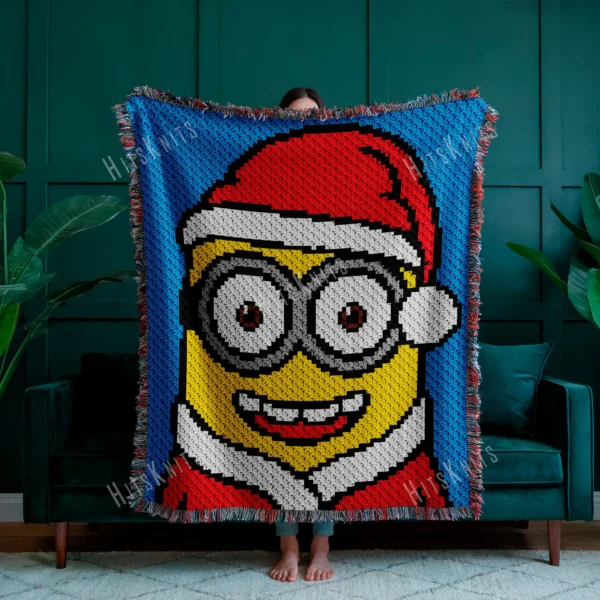Christmas Minion C2C crochet blanket pattern featuring a Minion in a Santa hat and winter outfit on a bright blue background, handmade pixel graphghan blanket design.