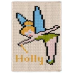 Pixel-style fairy blanket design featuring a blonde fairy with blue wings, green dress, pink striped stockings, and fairy shoes flying above the name Holly on a cream chunky knit background.