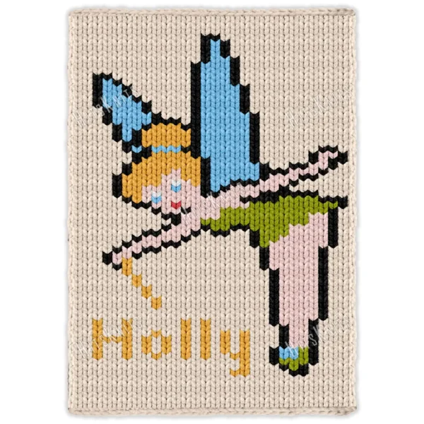 Pixel-style fairy blanket design featuring a blonde fairy with blue wings, green dress, pink striped stockings, and fairy shoes flying above the name Holly on a cream chunky knit background.