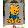 Winnie the Pooh C2C crochet blanket pattern featuring classic Pooh Bear in a blue shirt on a warm neutral background, handmade pixel graphghan blanket design.