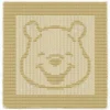 Pooh Knit and Purl Panel Knitting Pattern showing the face of Winnie the Pooh, a round bear head with small ears and a gentle smile, in raised knit and purl texture on a solid honey gold panel with a garter stitch border, worked in one color, 100 stitches x 146 rows.