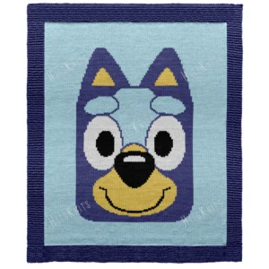 Bluey Intarsia Knit Baby Blanket Pattern showing a big blue heeler puppy face with pointy ears, golden ear and snout markings, large round eyes, and a smiling black nose, worked in stockinette intarsia colorwork with 5 colors: Navy, Sky, Yellow, White, and Black.