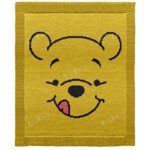 Pooh Bear Pram Blanket Knitting Pattern, a knitted baby blanket showing a golden honey bear face in intarsia colorwork with a black outline and a small red detail, worked in stockinette with a garter stitch border.