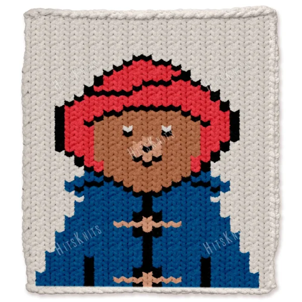 Paddington Bear Finger Knit Blanket Pattern - the storybook brown bear wearing a red hat and blue duffle coat on an ivory background, worked in stockinette colorwork intarsia with 6 colors: Ivory, Blue, Red, Black, Camel, Beige.