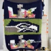 Seahawks Finger Knit Blanket Pattern - the Seattle Seahawks seahawk-head logo on a green field with Super Bowl LX 2026 emblems on a navy background, worked in stockinette colorwork intarsia with 8 colors: Navy, Green, White, Gray, Graphite, Sky, Lilac, Gold.
