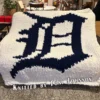 Detroit Tigers Blanket Finger Knitting Pattern - navy blue Old English D logo of the Detroit Tigers on a white background, bold MLB baseball team design, worked in stockinette colorwork intarsia with 2 colors: White and Navy.