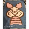 Piglet Finger Knit Blanket Pattern - smiling Piglet character on a soft blue background with pink ears and striped sweater, worked in stockinette colorwork intarsia with 4 colors: Blue, Brown, Pink, and Powder.