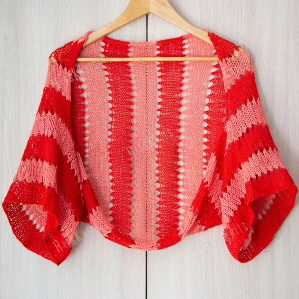 Easy striped lace bolero knitting pattern showing a loose summer shrug worked in thin cotton yarn with lace eyelet rows at each colour change, in coral and red stripes, one size fits most.