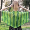 Easy striped lace bolero knitting pattern showing a loose summer shrug worked in thin cotton yarn with lace eyelet rows at each colour change, in coral and red stripes, one size fits most.