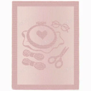 Embroidery Lover Blanket Knitting Pattern showing a textured design of embroidery tools, an embroidery hoop with a stitched heart, glasses, embroidery thread, and scissors, on a solid single-colour blanket with a garter stitch border, worked in one colour, 220 stitches x 396 rows.