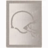 Football Helmet Blanket Knitting Pattern showing a textured silhouette of an American football helmet with a face mask, on a solid single-colour blanket with a garter stitch border, worked in one colour, 220 stitches x 396 rows.
