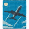 Plane in the Sky Blanket Knitting Pattern showing a dark grey airplane, an aeroplane in passenger jet shape, climbing on a diagonal across a blue sky with a white vapour trail, white clouds along the bottom and edges, and a pale yellow sun in the top corner, worked in jumbo yarn colorwork with 4 colors: Sky, Cloud, Gray, and Sun.