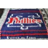Phillies Finger Knitting Blanket Pattern showing the red Phillies script logo with a white Liberty Bell above and a star below on a blue background, worked in stockinette colorwork intarsia with 3 colors: Blue, White, and Red.
