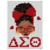 Delta Sigma Theta Chunky Throw Pattern showing a Black woman with curly hair, a large red bow, red glasses, gold hoop earrings, and the Greek letters of Delta Sigma Theta in red on a white background, worked in stockinette colorwork intarsia with 7 colors: White, Red, Brown, Camel, Black, Gold, and Burgundy.