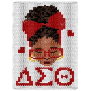 Delta Sigma Theta Chunky Throw Pattern showing a Black woman with curly hair, a large red bow, red glasses, gold hoop earrings, and the Greek letters of Delta Sigma Theta in red on a white background, worked in stockinette colorwork intarsia with 7 colors: White, Red, Brown, Camel, Black, Gold, and Burgundy.