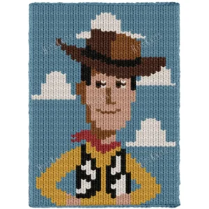 Woody Chunky Blanket Knitting Pattern showing a cowboy character in a wide brown hat with a smiling face and a yellow shirt, on a sky blue background with white clouds, worked in stockinette colorwork with 8 colors: Sky, Ivory, Yellow, Powder, Brown, Black, Camel, and Red.