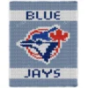 Blue Jays Finger Knitting Blanket Pattern showing the retro Toronto Blue Jays logo, a blue jay head over a red maple leaf with BLUE and JAYS in navy lettering on a sky blue background, worked in stockinette colorwork intarsia with 5 colors: Sky, White, Navy, Red, and Blue.