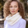 Free Easy Neck Warmer Knitting Pattern showing a soft cream white faux fur cowl worn close around the neck, knitted flat in garter stitch on 8 mm needles in one solid colour and seamed into a tube.