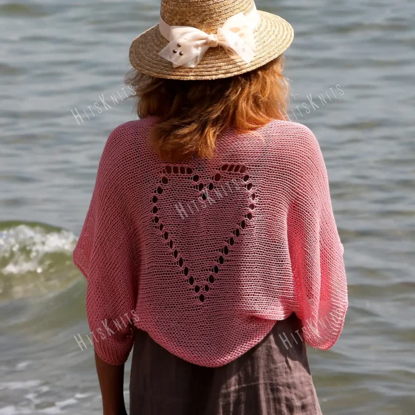 Lace Heart Bolero Knitting Pattern showing a lightweight pink lace shrug with an eyelet heart motif on the back, worked in sport weight cotton, sizes XS to 4XL.