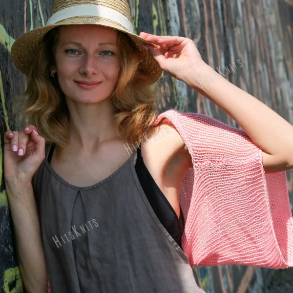 Lace Heart Bolero Knitting Pattern showing a lightweight pink lace shrug with an eyelet heart motif on the back, worked in sport weight cotton, sizes XS to 4XL.