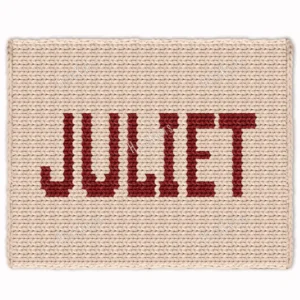Juliet Chunky Blanket Knitting Pattern showing the name Juliet in deep red block letters running along the length of a soft cream blanket, worked in stockinette colorwork intarsia with 2 colors: Cream and Red.
