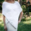 Free Faux Fur Wedding Poncho Knitting Pattern showing a soft white fluffy triangular poncho draped over the shoulders with a long front point, worked in garter stitch, one size fitting S, M, and L.