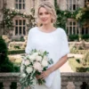 Free Faux Fur Wedding Poncho Knitting Pattern showing a soft white fluffy triangular poncho draped over the shoulders with a long front point, worked in garter stitch, one size fitting S, M, and L.