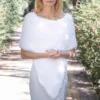 Free Faux Fur Wedding Poncho Knitting Pattern showing a soft white fluffy triangular poncho draped over the shoulders with a long front point, worked in garter stitch, one size fitting S, M, and L.