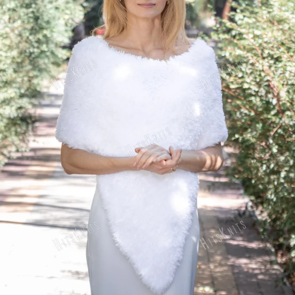 Free Faux Fur Wedding Poncho Knitting Pattern showing a soft white fluffy triangular poncho draped over the shoulders with a long front point, worked in garter stitch, one size fitting S, M, and L.