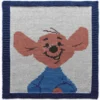 Roo Intarsia Knit Panel Pattern showing the little kangaroo joey from Winnie the Pooh with soft almond fur, rounded eyes, and a small black nose on a white ground with a blue garter stitch border, worked in stockinette intarsia colorwork with 7 colors: Blue, White, Sky, Almond, Brown, Black, and Pink.