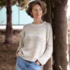 Cozy Women's Basic Sweater Knitting Pattern showing a relaxed drop-shoulder pullover in marled cream, oat, and sand, worked in stockinette stitch with rolled hem, cuffs, and neckline, sizes S to 2XL.