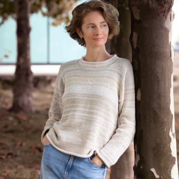 Cozy Women's Basic Sweater Knitting Pattern showing a relaxed drop-shoulder pullover in marled cream, oat, and sand, worked in stockinette stitch with rolled hem, cuffs, and neckline, sizes S to 2XL.