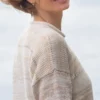 Cozy Women's Basic Sweater Knitting Pattern showing a relaxed drop-shoulder pullover in marled cream, oat, and sand, worked in stockinette stitch with rolled hem, cuffs, and neckline, sizes S to 2XL.