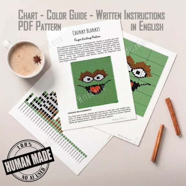 Oscar the Grouch Finger Knit Throw Pattern - grinning green grouch face with shaggy brown brows, big white googly eyes, and a wide black mouth with a red tongue, worked in stockinette colorwork intarsia with 5 colors: Green, Black, Brown, White, Red.
